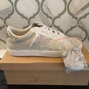 Pair of Vintage Havana tennis shoes. Shoes are cream color with a star on side.